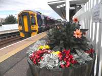 Edinburgh train waiting to leave Cowdenbeath on 1 August, alongside an impressive floral display maintained by the local Rotary Club.<br><br>[John Yellowlees 01/08/2013]