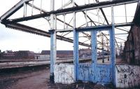 The derelict Manors North in the 1980s looking south east along platform 1 with 2-5 off to the left. The ECML platforms 6-9 of Manors East run across the picture in the background (accessed via the white footbridge) and the spire of Newcastle's All Saints Church is visible on the far right through the shell of the building. No trace remains of Manors north station but the 2 surviving platforms at Manors East are currently (2013) served by Northern trains on the Morpeth - Metro Centre route. <br><br>[Ian Dinmore //]