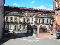 The exit from the Caledonian Railway's Princes Street station onto Rutland Street in August 2013. The framework and metal gates still survive, although nowadays the station and platforms that once stood behind the camera have given way to car parking and offices serving Edinburgh's financial district.<br><br>[John Furnevel 09/08/2013]