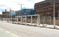 Looking south across Haymarket Terrace on 9 August 2013. Station redevelopment work continues in the background beyond the tram stop, with the 1842 E&G station building on the far left of the picture.<br><br>[John Furnevel 09/08/2013]