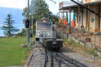 With Lake Geneva far below, units 305 and 301 propel two wagons for the Rochers de Naye summit hotel into the passing loop at Caux station. Although 305 appears identical to its 1983 sister units it was only built in 2010.<br><br>[Mark Bartlett 09/09/2013]