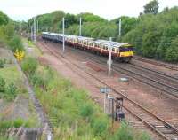 The 10.42 Milngavie - Lanark passing Law Junction on 23 September 2013. While the loading bank still survives on the left, little trace remains of the station that served passengers here between 1880 and 1965 [see image 6629]. <br><br>[John Furnevel 23/09/2013]