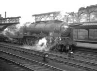 A summer Saturday <I>through</I> service, photographed alongside platform 4 at Carlisle on 4 August 1962. The train is the 11.50am Glasgow Central - Manchester / Morecambe. Locomotive in charge is Polmadie Royal Scot no 46121 <I>Highland Light Infantry, City of Glasgow Regiment</I>. <br><br>[K A Gray 04/08/1962]