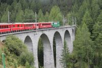 The amazing loops, spirals, tunnels and viaducts of the Rhaeitian Railway Albula line have been made a UNESCO world heritage site. Ge 4/4 III electric loco No. 647 <I>Grusch</I> crosses one of many tall slender structures on a Chur to St. Moritz train shortly after leaving Bergun. <br><br>[Mark Bartlett 16/09/2013]