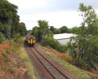 The 09.41 Girvan - Kilmarnock runs round the curves shortly after leaving Maybole on 23 September 2013. On the right is the site of the original Maybole terminus, which later became the goods station, all since redeveloped for industrial use.<br>
<br><br>[Colin Miller 23/09/2013]