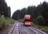 The Oberweissbacher Bergbahn's standard-gauge passenger coach (carried piggyback on a 1.8m gauge Rollwagen) inches down through the mid-way crossing loop on the funicular on 28th June 2013. Taken from the railway's sloping split-level passenger coach, ascending the 1 in 4 gradient. [See image 43995]<br><br>[David Spaven 28/06/2013]