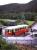 Passengers board the Oberweissbacher Bergbahn's standard-gauge passenger coach (carried piggyback on a 1.8m gauge Rollwagen) at the Obstfelderschmiede terminus on 29th June 2013. Note the elderly Deutsche Bahn wagon on the chord siding linking to the adjacent Schwartzatalbahn.<br><br>[David Spaven 29/06/2013]