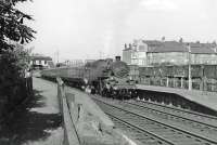 80020 stops at Crossmyloof with an East Kilbride train in June 1963. The vans in the siding contain copies of the Radio Times from the Hairmyres factory of Waterlow & Sons awaiting shipment south.  Newsprint went up to Hairmyres in trains of about 12 tarpaulin-covered wagons which, due to their weight and the gradient involved, required ex-WD 2-8-0s.<br><br>[John Robin 13/06/1963]