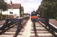 Looking over the buffer stops at Isfield on the Lavender Line in December 1988. Standing at the platform with a train is 0-6-0ST No 62 <I>Ugly</I> (RSH 7673 of 1950). <br><br>[Ian Dinmore /12/1988]