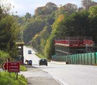 Entrance to the Borders Railway construction site on the A7 between Newtongrange and Gorebridge, with the new Gore Glen bridge taking shape beyond. View is south on Sunday 20 October 2013.  <br><br>[John Furnevel 20/10/2013]