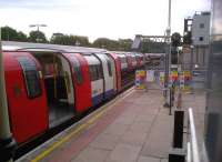 Not quite as busy as it looks. Northern Line trains stand in platforms 1 and 2 at High Barnet as a third train leaves platform 3 at the end of the morning rush hour on 5 August 2013. Notice the signalling centre (grey building on far right).<br><br>[Ken Strachan 05/08/2013]