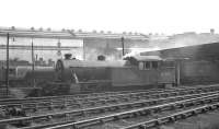 View south across a busy Heaton shed yard in the late 50s/early 60s towards Parsons engineering works. Locomotives in attendance include V3 67605 nearest the camera and V2 60806 standing in the left background.<br><br>[K A Gray //]