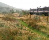 Nice day for a walk... at least it was when we set out! A fine misty rain arrives from the west near Strathcarron station on a Monday afternoon in late September 2009, just as the 11.01 ex-Inverness passes by on its way to Kyle of Lochalsh.<br><br>[John Furnevel 28/09/2009]