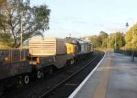 The morning Crewe to Sellafield flasks rumble through Grange-over-Sands station behind DRS EE Type 3s 37608 and 37682 on 17 October 2013.<br><br>[Mark Bartlett 17/10/2013]