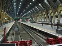 Platforms 1 to 4 at Kings Cross are unusually devoid of stock at 18.45 on 4 December, with only the lights of the Thunderbird class 67 stabled in the siding beyond the platforms visible.<br><br>[David Pesterfield 04/12/2013]