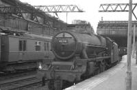 Activity at Glasgow Central on 23 June 1962 as Jubilee 45741 <I>Leinster</I> prepares to back onto the 11.50am train to Morecambe. Meantime, in the background, one of the recently introduced <I>Blue Trains</I> glides quietly past. <br><br>[John Robin 23/06/1962]