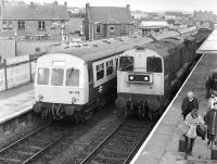 Looking north from the footbridge at Cowdenbeath in the early 1980s as DMU 101315 on an outer Fife Circle service is passed by 20203 with a goods train for Dunfermline Upper.<br><br>[Bill Roberton //198X]