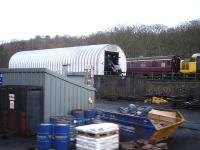 The open smokebox of 60007 <I>Sir Nigel Gresley</I> can be seen protruding from the purpose built maintenance facility on the east side of Grosmont NYMR Shed complex on 15 December. The nose of large logo liveried class 37 no 37264 is also in the picture.<br><br>[David Pesterfield 15/12/2013]