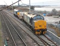 Diverging onto the Bare Lane chord at Hest Bank on 18 December is this trip working to Heysham Power Station from Sellafield. DRS 37688 brings up the rear of the train conveying a single flask led by 37606. The train will reverse at Morecambe to access the Heysham branch. <br><br>[Mark Bartlett 18/12/2013]