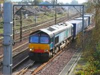 DRS 66406 lifts the Tesco containers out of the down loop at Beattock on 12 October 2006, after being sidelined to make way for a northbound Voyager. [See image 11726]<br><br>[John Furnevel 12/10/2006]