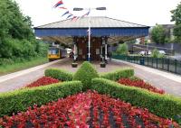 A Northern service to Blackpool North photographed in June 2012 calling at Poulton-le-Fylde station. The platform decoration includes bunting and avery tidy flower bed.<br><br>[John McIntyre 16/06/2012]