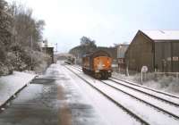 A class 37 coming off a spell of snowplough duty runs through Brundall station in March 2005.<br><br>[Ian Dinmore /03/2005]