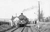 The SLS <I>'Farewell to Peebles'</I> railtour on the level crossing at Pomathorn on 3 February 1962. The special is hauled by J37 0-6-0 no 64587 [see image 28603]. The large building in the left background is Pomathorn paper mill, which closed in 1975.<br><br>[David Stewart 03/02/1962]
