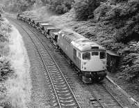 26024 heads a ballast train clockwise round the Edinburgh suburban line past the site of Blackford Hill signalbox on 8 August 1986.  The connection to Newington Goods diverged to the left.<br><br>[Bill Roberton 08/08/1986]