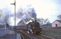 The 5.8pm service from St Enoch about to enter Busby station on 8 April 1966. Locomotive in charge is Corkerhill standard class 4 tank 80004.<br><br>[G W Robin 08/04/1966]