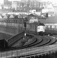 A class 37 with a coal train crossing the River Tyne from Newcastle to Gateshead via the King Edward Bridge in October 1975.<br><br>[John Furnevel 20/10/1975]