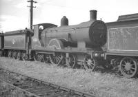 Drummond T9 'Greyhound' 4-4-0 no 30120 in the sidings at Eastleigh in August 1960 - prior to its transformation. [See image 41020]<br><br>[K A Gray 09/08/1960]