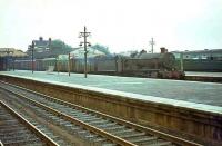 7906 <I>Fron Hall</I> takes a westbound parcels through Basingstoke in August 1964.<br><br>[John Robin 24/08/1964]