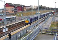 View over Livingston North station on 30 January 2014 as the 10.36 ex-Milngavie arrives at platform 1 with a service for Edinburgh Waverley.<br><br>[John Furnevel 30/01/2014]