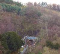 The southern portal of Holme tunnel, seen through the trees on 10 February 2014. It was this hillside that had moved, causing the tunnel walls to distort and leading to the major engineering works currently underway to reline the tunnel. [See image 46314]<br><br>[John McIntyre 10/02/2014]