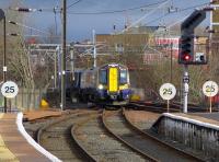 The 10.30 ex Glasgow Central snakes across the layout at the north end of Ayr station from the down line into Platform 1.<br>
<br><br>[Colin Miller 21/02/2014]