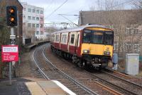 318259 enters Partick with an eastbound service on 22 February.  The platforms of the earlier station survive in the background beyond the Dumbarton Road bridge. <br><br>[Bill Roberton 22/02/2014]