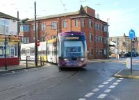 <I>Flexity</I> tram 013 swings round the corner into the Fleetwood Ferry stop on a service from Starr Gate on 27 February. The Blackpool & Fleetwood Tramway is double track along its entire length apart from this loop at the northern terminus.<br><br>[Mark Bartlett 27/02/2014]