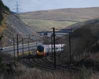 A northbound service climbing fast on the reverse curves just north of Harthope Viaduct.<br><br>[Ewan Crawford 03/03/2014]