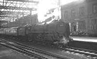 Kingmoor shed's Britannia Pacific no 70002 <I>Geoffrey Chaucer</I> stands in the shadows at Carlisle platform 3 on 18 April 1964. The locomotive has recently taken over the 9.25am Crewe - Perth train. [See image 24632]  <br><br>[K A Gray 18/04/1964]