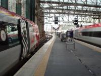 Newly arrived from Crewe at Glasgow Central on 7 March, Voyager 221118 in Platform 1 will head for London Euston via Birmingham at 10am. Pendolino 390156 in Platform 2 is forming the 9.40am Euston departure via the traditional direct route.  <br><br>[Mark Bartlett 07/03/2014]