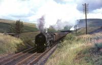 Britannia Pacific no 70003 <I>John Bunyan</I> northbound on Beattock approaching the summit distant signal on the last day of July 1965. The exhaust beyond the road bridge in the background is from banker 80045 bringing up the rear of the train.   <br><br>[John Robin 31/07/1965]