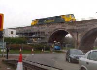 Coton Arches are a well known local landmark, just North of the former Chilvers Coton suburban station [see image 26106]. The viaduct is nearing the end of a 10-week programme of refurbishment; 70020 is seen inspecting the works on a Northbound Freightliner - the first wagon being empty.<br><br>[Ken Strachan 14/03/2014]