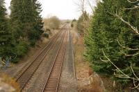 There was not much to see as far as the former Adlestrop station was concerned when it was visited on 4 March 2014. The degraded remains of the platforms were just visible and the station house still stood as a private residence through the trees on the left. [Ref query 3485]. Photographed from the bridge carrying the A436 over the railway.<br><br>[John McIntyre 04/03/2014]