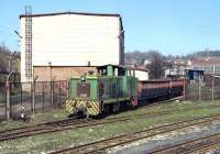 In addition to three B-B diesel hydraulics of class 740, the Banovici coal railway possesses three 4w shunters of class 720, which are employed at the loading point at Turija and here at the works in Banovici. On 14 March no. 720 003 emerges from the works yard with two hopper wagons which have been receiving attention.  The main part of the works seems to handle wagons and steam overhauls, while the tall building behind the loco deals with maintenance of the diesel fleet.<br><br>[Bill Jamieson 14/03/2014]