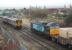 The points have been changed and DRS 57003 is just about to set off along the Heysham Branch on 8 January as 156454 passes on a Morecambe to Lancaster service. Moments later the junction disappeared from view briefly when a cloud of blue smoke erupted from the Class 57 as it moved off. <br><br>[Mark Bartlett 08/01/2014]