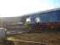 View from a train passing the National Railway Museum, York, on 4 February 2014. A4 Pacific 60009 <I>Union of South Africa</I> is in light steam, with the smoke-box door open, while West Coast Railway 37518, still carrying the Ian Riley name from its previous ownership, stands alongside. <br><br>[David Pesterfield 04/02/2014]