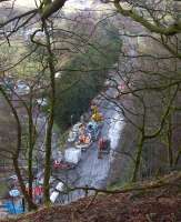 Looking down to the trackbed from above the southern portal of Holme Tunnel on 10 February 2014 as a delivery of cement is being trans-shipped from rail to road before being taken into the tunnel. [See image 46312]<br><br>[John McIntyre 10/02/2014]