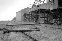 Sidings have been recycled as storage racks for pipework at the closed (by fire on 9 September 1967) Michael Colliery, East Wemyss, Fife.  The shafts were retained for pumping galleries worked from the Frances Pit.  The site has since been cleared. Photographed in April 1992.<br><br>[Bill Roberton /04/1992]