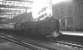 Kingmoor shed's Britannia Pacific no 70002 <I>Geoffrey Chaucer</I> stands in the shadows at Carlisle platform 3 on 18 April 1964. The locomotive has recently taken over the 9.25am Crewe - Perth train. [See image 24632]  <br><br>[K A Gray 18/04/1964]