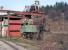 Another view of woebegone 0-6-0T USA-type tank 62.677 [see image 46965] taken on the afternoon of 13 March 2014. The high level narrow gauge tracks here at Oskova are on the top of the embankment on the right (just above the top of the shadow cast by the lighting mast).	<br><br>[Bill Jamieson 13/03/2014]